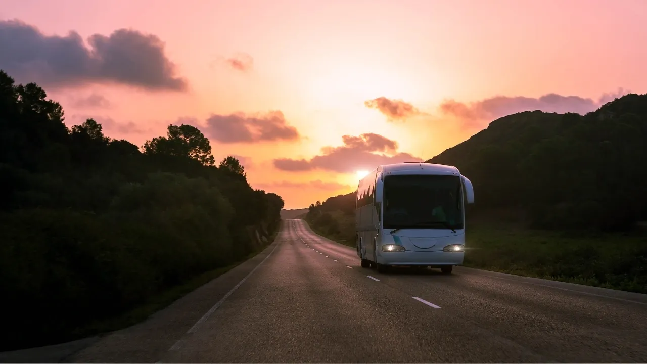 A Bergslagsbuss coach on the road through a landscape